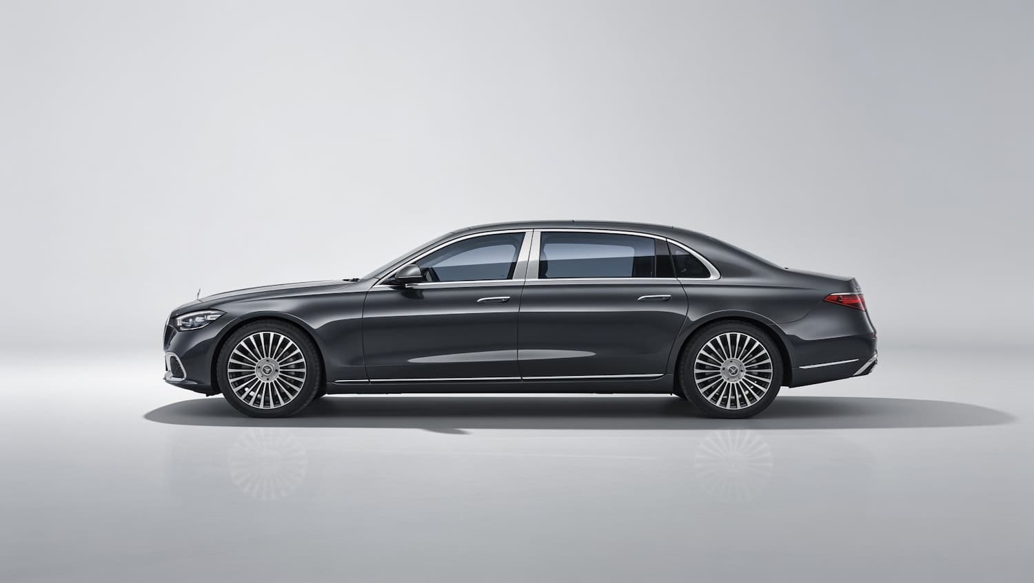 Dark metallic sport sedan shown in side profile against a plain studio background
