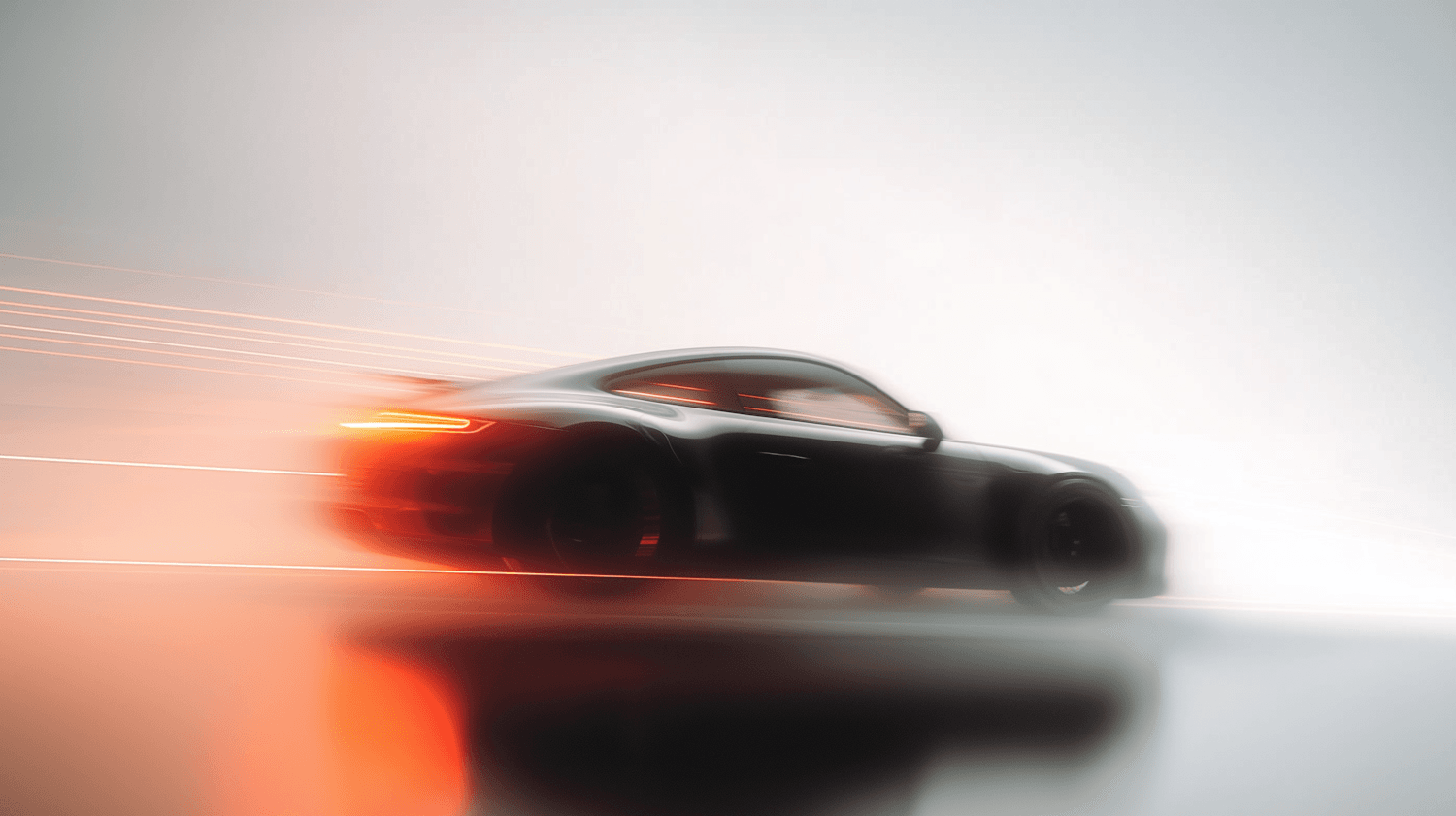 Dark sport car in motion with light trails streaking behind it